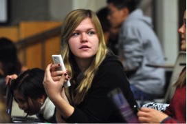A college student uses an electronic “clicker” to participate in class Photo by Patrick Campbell/University of Colorado